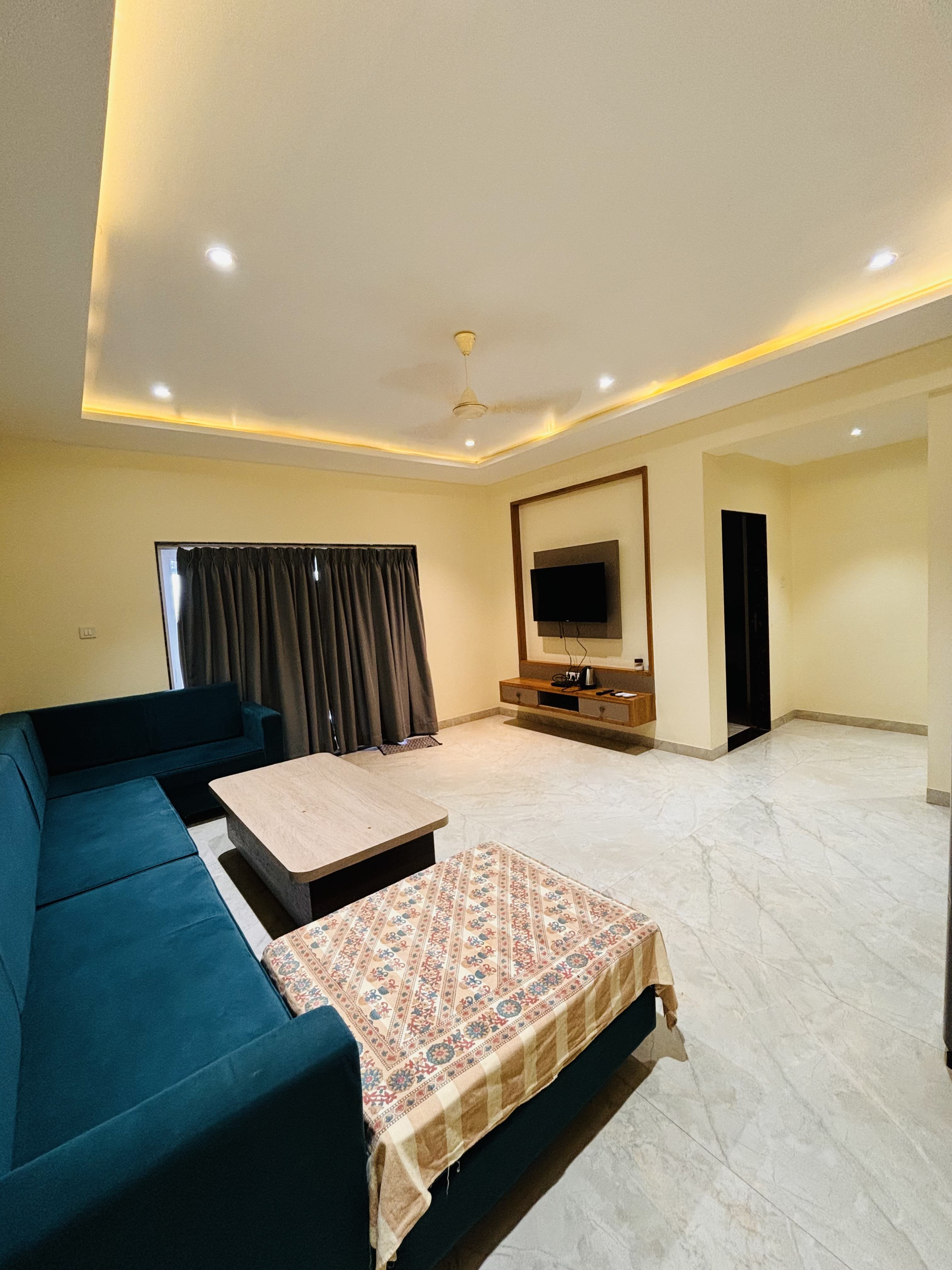 Living room with TV at Panchgani holiday home